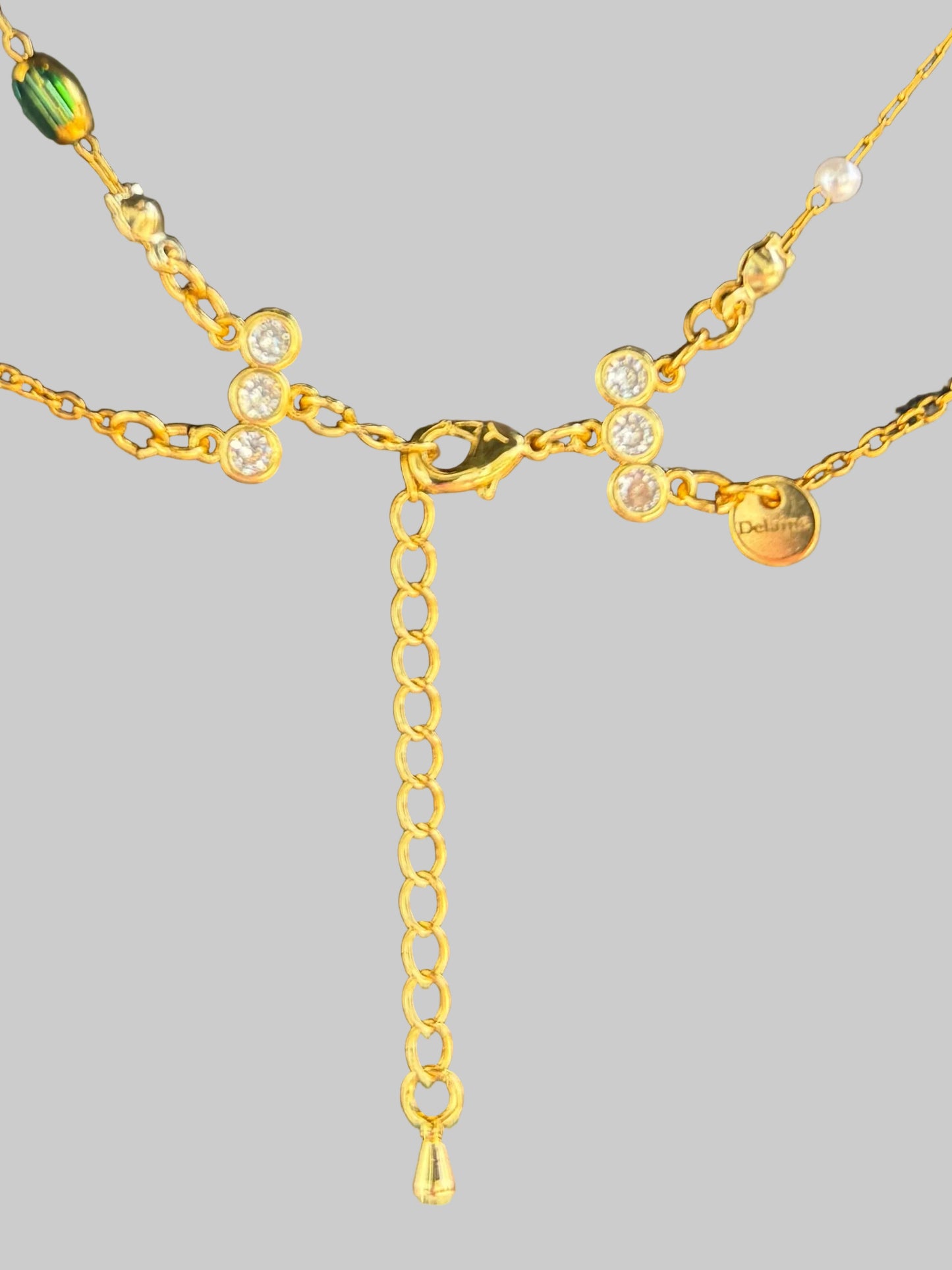 Gold chain necklace on a textured dark surface